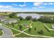 Scenic aerial view showcasing the community's green spaces, park, lake, and gazebo, highlighting its inviting outdoor spaces at 169 Jensen Dr, Groveland, FL 34736