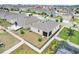 Aerial view of the home and its surrounding neighborhood, showcasing privacy fences and mature landscaping at 169 Jensen Dr, Groveland, FL 34736