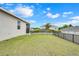 Spacious backyard with green grass and a black metal fence providing privacy and security at 169 Jensen Dr, Groveland, FL 34736