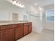 Bathroom featuring granite countertops, double vanity, and glass shower at 169 Jensen Dr, Groveland, FL 34736