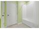 Bright bathroom featuring a white tub and tiled shower, with a white door to the left at 169 Jensen Dr, Groveland, FL 34736