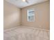 Simple bedroom featuring neutral carpet, a ceiling fan, and a window bringing in natural light at 169 Jensen Dr, Groveland, FL 34736