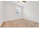 Simple bedroom featuring neutral carpet, a ceiling fan, and a window bringing in natural light at 169 Jensen Dr, Groveland, FL 34736