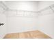 Walk-in closet with wire shelving in neutral color palette at 169 Jensen Dr, Groveland, FL 34736