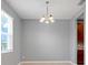 Bright dining area featuring a modern chandelier, window, and neutral wall paint at 169 Jensen Dr, Groveland, FL 34736