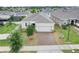 Charming single-story home with a well-maintained lawn and a brick-paved driveway at 169 Jensen Dr, Groveland, FL 34736