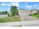 Inviting single-Gathering home featuring a well-manicured lawn and brick paver driveway at 169 Jensen Dr, Groveland, FL 34736
