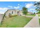 Attractive single-story home featuring a lush green lawn and a brick paver driveway at 169 Jensen Dr, Groveland, FL 34736