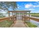 Picturesque gazebo with benches overlooking the lake, creating a serene and relaxing atmosphere for residents and guests at 169 Jensen Dr, Groveland, FL 34736