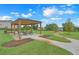 Inviting picnic area featuring a covered pavilion with tables and a scenic view of the community's green space and lake at 169 Jensen Dr, Groveland, FL 34736