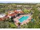 Aerial view of the community's outdoor pool, amenities, and meticulously landscaped grounds, showcasing resort-style living at 2112 Saint Ives Ct, Clermont, FL 34711