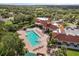 This aerial view showcases the community pool, clubhouse, manicured grounds, and overall tranquil setting at 2112 Saint Ives Ct, Clermont, FL 34711