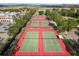 Overhead shot of well-maintained tennis courts in a community near a lake, offering a great recreational amenity at 2112 Saint Ives Ct, Clermont, FL 34711