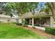 Home exterior with backyard and screened lanai at 2112 Saint Ives Ct, Clermont, FL 34711