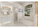 Bright bathroom with a soaking tub, walk-in shower and a vanity with framed mirror at 2112 Saint Ives Ct, Clermont, FL 34711