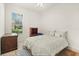 This bedroom features neutral walls, a full bed, a large window, and side table at 2112 Saint Ives Ct, Clermont, FL 34711
