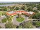 Expansive clubhouse featuring a circular driveway, lush landscaping, and a refreshing pool at 2112 Saint Ives Ct, Clermont, FL 34711