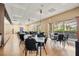 Large dining area featuring neutral decor, with plenty of tables and chairs, and lots of natural light for comfortable meal times at 2112 Saint Ives Ct, Clermont, FL 34711