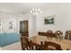 Formal dining room with wooden table, decorative chandelier, and classic design at 2112 Saint Ives Ct, Clermont, FL 34711