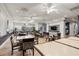 Spacious dining room with wood flooring and lots of tables and chairs, perfect for community gatherings and shared meals at 2112 Saint Ives Ct, Clermont, FL 34711