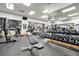 Well-equipped gym featuring modern exercise machines, weights, and a mirrored wall at 2112 Saint Ives Ct, Clermont, FL 34711