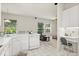 Bright kitchen with white cabinetry, an adjacent breakfast area, and an open view of the living room at 2112 Saint Ives Ct, Clermont, FL 34711