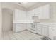 Well-lit kitchen featuring white cabinets, tile flooring, and ample counter space at 2112 Saint Ives Ct, Clermont, FL 34711