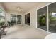 Relaxing screened lanai with ceiling fan and sliding glass doors at 2112 Saint Ives Ct, Clermont, FL 34711