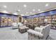 Well-stocked library with comfortable seating and abundant natural light at 2112 Saint Ives Ct, Clermont, FL 34711