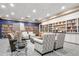 Bright library with extensive bookshelves, cozy seating, and stylish decor at 2112 Saint Ives Ct, Clermont, FL 34711