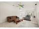 Bright living room featuring tile floors, a ceiling fan and a view into the kitchen and patio at 2112 Saint Ives Ct, Clermont, FL 34711
