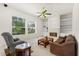 Cozy living room with built-in shelving, fireplace, large windows and comfortable seating at 2112 Saint Ives Ct, Clermont, FL 34711