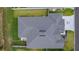 Overhead shot of a well-maintained house with a large roof, surrounded by a manicured lawn and a gray driveway at 2129 Landrea Loop, The Villages, FL 32163