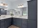 The bathroom features a double vanity with framed mirrors, dark cabinets, and modern lighting fixtures at 2129 Landrea Loop, The Villages, FL 32163