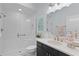 Modern bathroom showcasing a glass-enclosed shower, vanity with gold hardware, and decorative artwork at 2129 Landrea Loop, The Villages, FL 32163