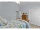 Cozy bedroom boasts a ceiling fan, a dresser, and ample storage within the double door closet at 2129 Landrea Loop, The Villages, FL 32163