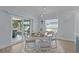 Bright dining area features a round table, chairs, sliding glass doors, and views of the outdoor space at 2129 Landrea Loop, The Villages, FL 32163