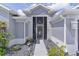 Charming front entrance walkway featuring beautiful landscaping leading up to the front door of this single Gathering home at 2129 Landrea Loop, The Villages, FL 32163
