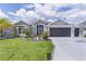 Beautiful single Gathering home with a well manicured lawn and landscaping with a two car garage at 2129 Landrea Loop, The Villages, FL 32163