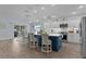 A spacious kitchen features a large blue island with countertop seating and modern, stainless steel appliances at 2129 Landrea Loop, The Villages, FL 32163