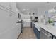 Bright kitchen with white cabinets, stainless appliances, stylish backsplash, and farmhouse sink at 2129 Landrea Loop, The Villages, FL 32163