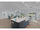 Kitchen island with a sink, seating, and open access to a living room, great for entertaining at 2129 Landrea Loop, The Villages, FL 32163
