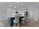 A kitchen features a large island with countertop seating, modern lighting, and stainless steel appliances at 2129 Landrea Loop, The Villages, FL 32163