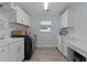 Functional laundry room equipped with washer and dryer, sleek white cabinets, and countertop for folding at 2129 Landrea Loop, The Villages, FL 32163