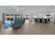 Open concept living area with wood floors, bar seating, and views of the lanai at 2129 Landrea Loop, The Villages, FL 32163
