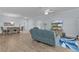 Living room and dining area combination with wood floors and a comfortable seating arrangement at 2129 Landrea Loop, The Villages, FL 32163