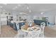 Open-concept living space featuring a kitchen island, dining area, and cozy living room with modern decor at 2129 Landrea Loop, The Villages, FL 32163