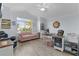 Comfortable living room featuring a large window and a cozy couch provides a welcoming space to relax and unwind at 2129 Landrea Loop, The Villages, FL 32163