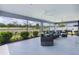 Relaxing screened patio with comfortable seating and views of the serene lake enhances the outdoor experience at 2129 Landrea Loop, The Villages, FL 32163