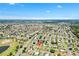 Distant aerial view of home in a vast community with golf course, ponds, and roads at 2167 Kerwood Loop, The Villages, FL 32162